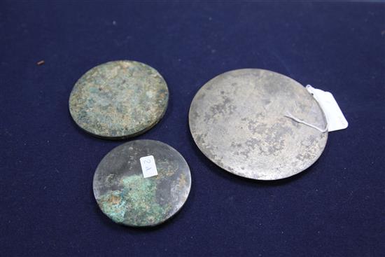Three Chinese bronze mirrors, Tang dynasty or later, diameter 8.2cm - 13cm